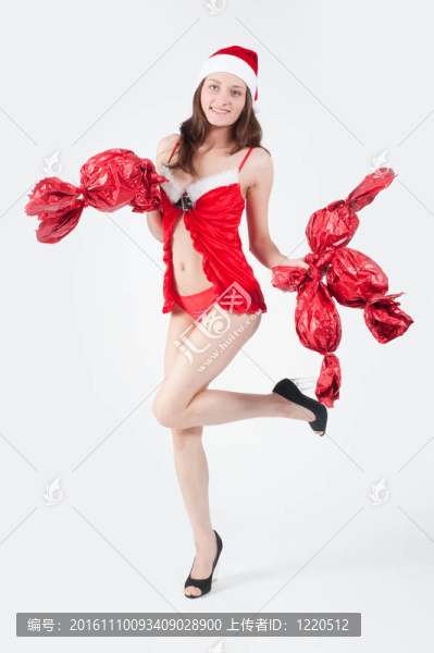 美麗和性感的圣誕婦女與糖果