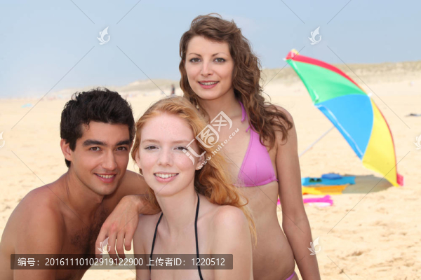三個朋友在海灘上玩的開心