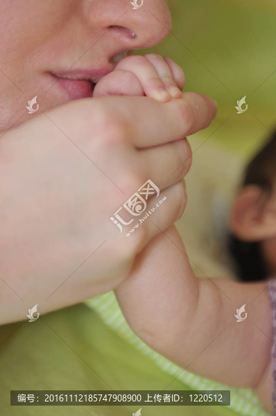 年輕漂亮母親抱著小孩子手