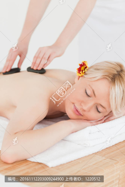 漂亮女人接受按摩與熱石
