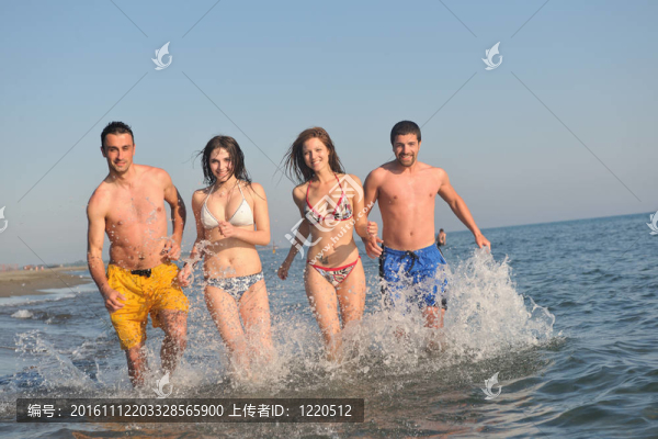 快樂人團(tuán)體在海灘上玩樂和跑步