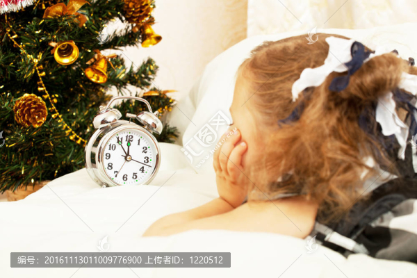 小女孩望著鬧鐘，期待圣誕節(jié)來(lái)臨