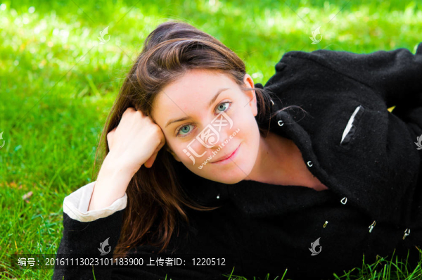 美麗的年輕迷人的女人在綠色背景的戶外肖像