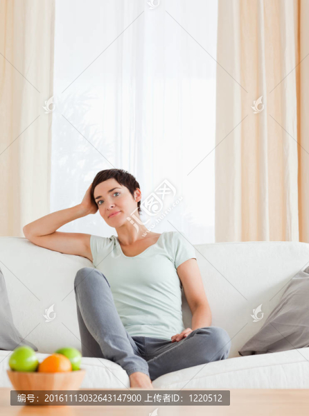 一個(gè)坐在沙發(fā)上的可愛女人的畫像