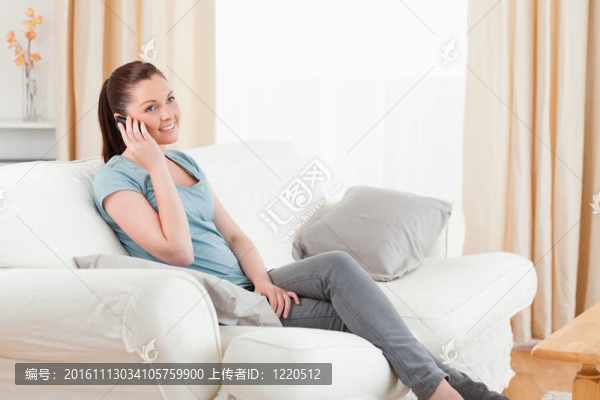 美女在手機(jī)上坐在沙發(fā)上