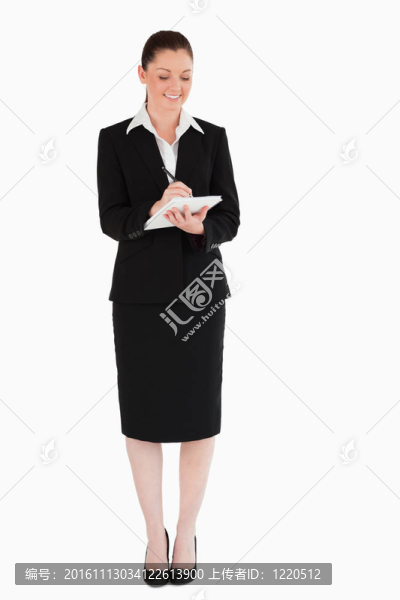 美麗的女人在西裝寫在筆記本上