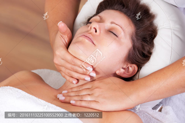 年輕漂亮的女人得到面部按摩