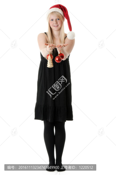 在Santa的帽子里的年輕漂亮的女孩