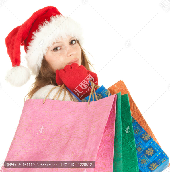 穿著Santa帽子的女孩帶著圣誕禮物帶著購物袋；白色背景