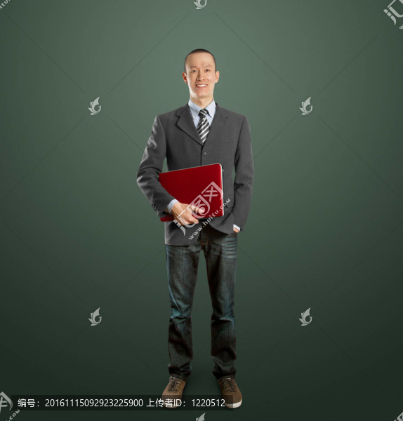 男性在西裝與筆記本電腦在他的手中
