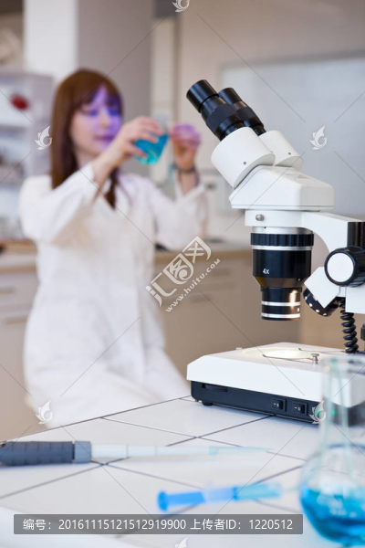 漂亮的女研究員在實驗室用顯微鏡