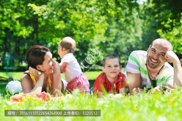 快樂的年輕夫婦和他們的孩子在公園玩得開心