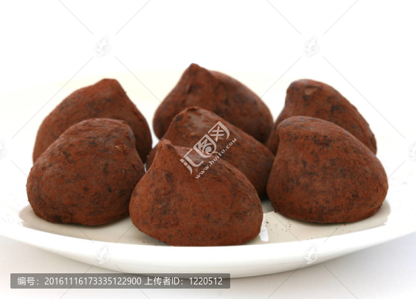 覆蓋在可可粉白巧克力松露巧克力糖果盤和背景