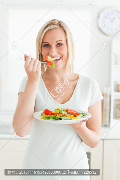 迷人的女人享受混合沙拉肖像