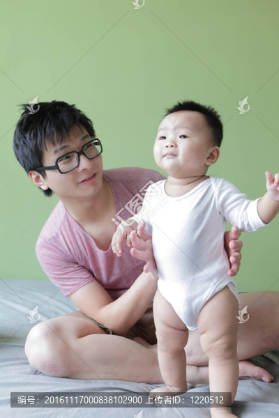 年輕的父親快樂的玩他的寶貝