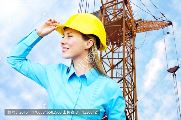 站在建筑物背景上的年輕建筑師女士戴著防護(hù)頭盔