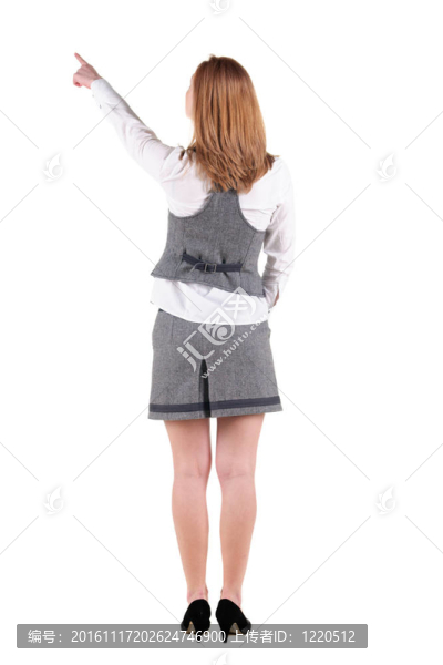美麗的年輕女子指著墻上。后視圖。