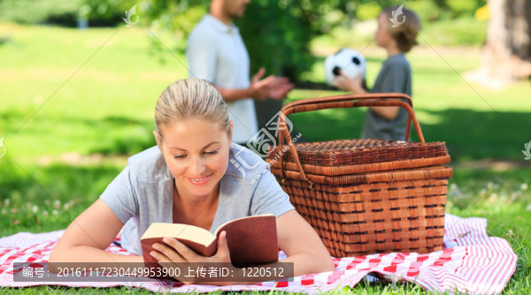 爸爸和兒子在踢足球，媽媽在看書