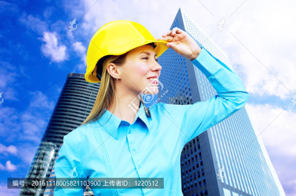 站在建筑物背景上的年輕建筑師女士戴著防護(hù)頭盔
