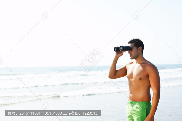 男孩用望遠鏡望著海邊