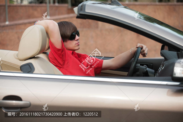 駕駛一輛敞篷車的年輕人