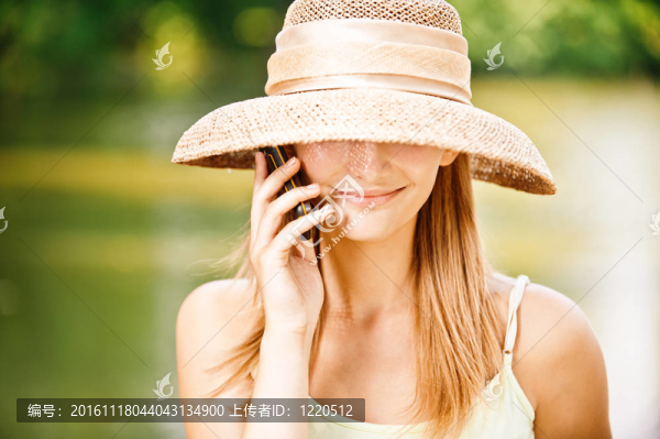 戴電話的戴著帽子的女孩