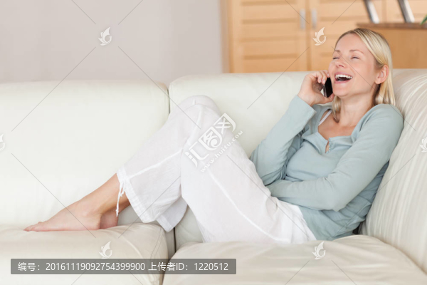 在沙發(fā)上享受電話的女人