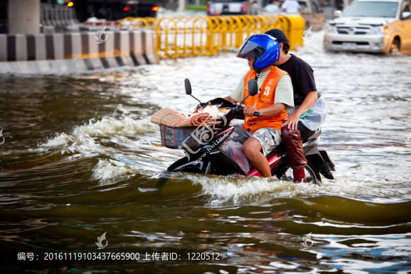 兩個騎摩托車的人在洪水中航行