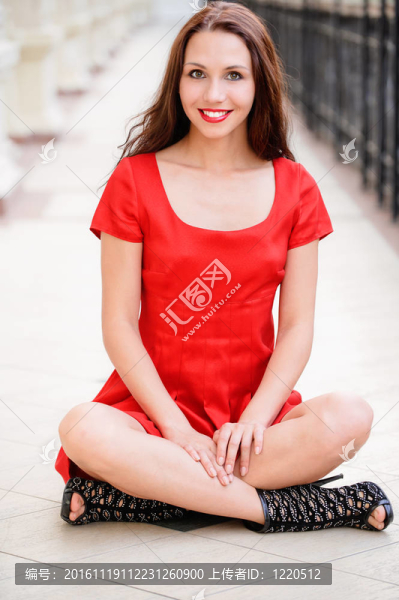 美麗的女孩坐在地板上