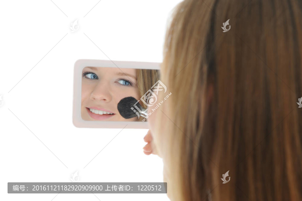 用粉末和刷子的女人