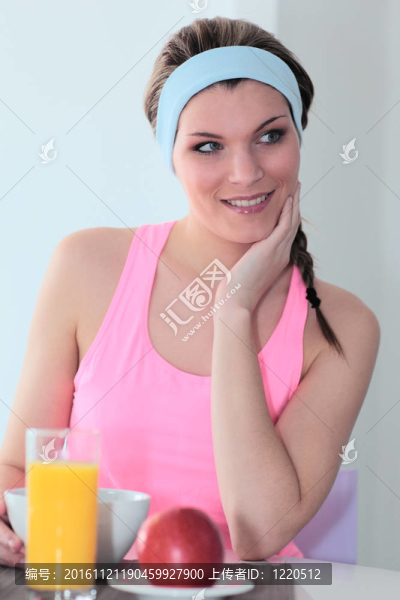 年輕的運(yùn)動(dòng)?jì)D女在家吃早餐