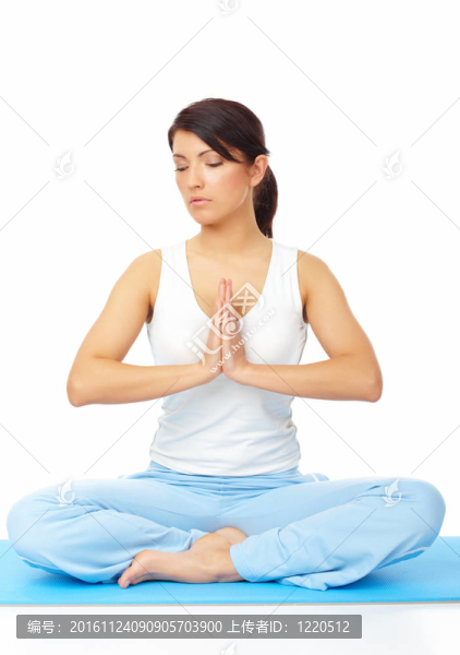 年輕的女人在墊子上做瑜伽練習(xí)