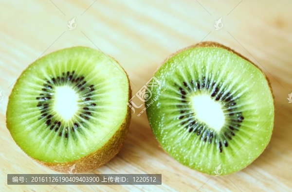 兩個(gè)獼猴桃半放在松樹桌上