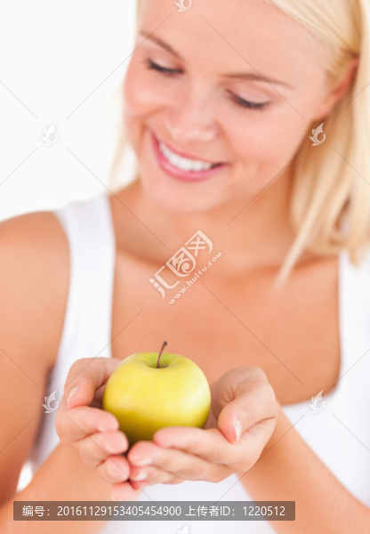 漂亮的金發(fā)女人拿著一個蘋果