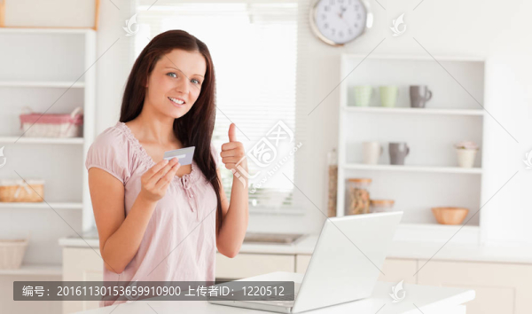用信用卡和拇指向上的女人