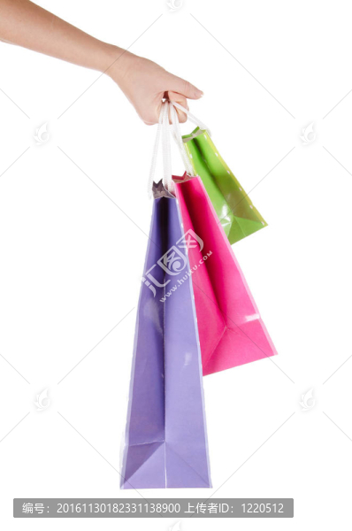 明亮的禮品袋在白色的手孤立