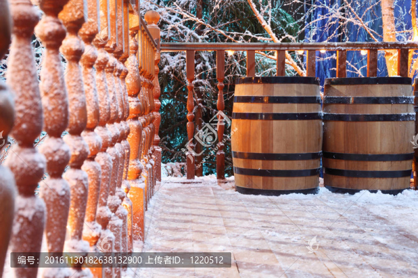 木桶和雪中美麗的木欄桿；雪在欄桿后面的Spruce