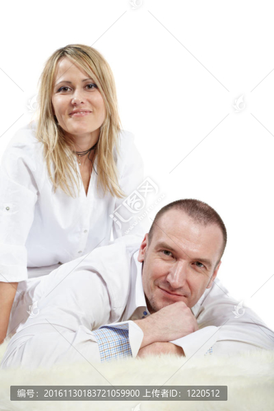 男人穿白襯衫躺在白色的長(zhǎng)毛地毯；女人坐在后面一點(diǎn)。