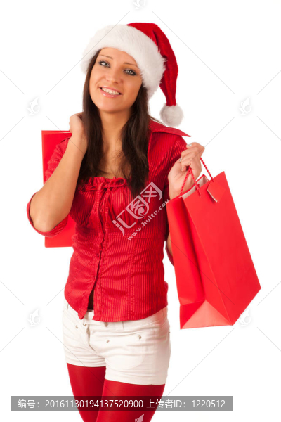 漂亮的女孩穿著像Santa的圣誕禮物