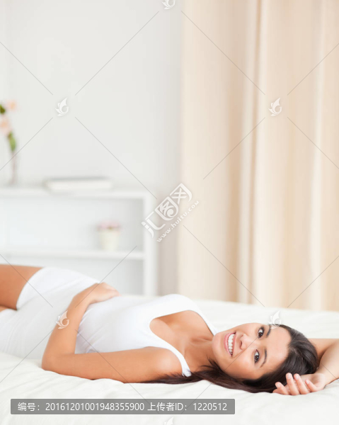 微笑的女人躺在床上