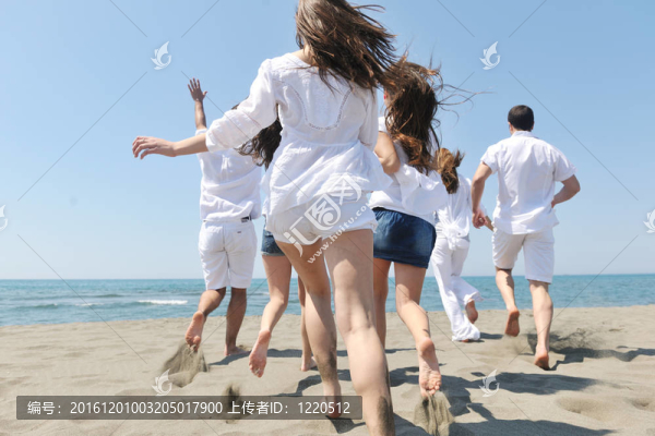 快樂(lè)人團(tuán)體在海灘上玩樂(lè)和跑步