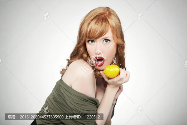 年輕快樂(lè)的女人拿著一個(gè)檸檬