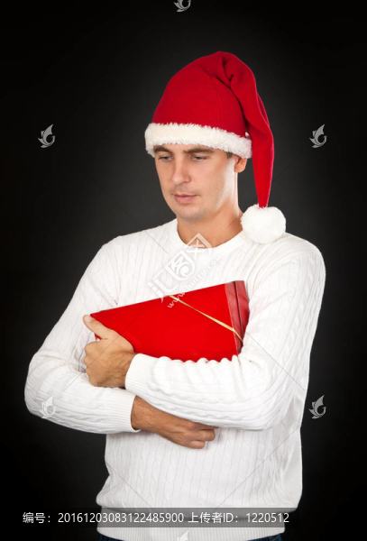 悲傷的男人在一頂帽子Santa的禮物