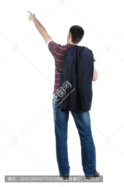 指著墻的年輕人。后視圖。