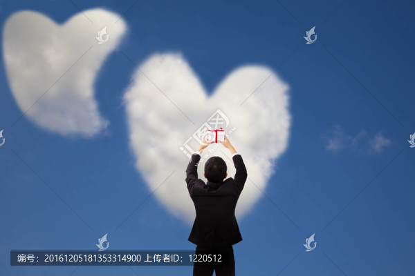 男人捧著禮物，兩顆心和愛的云