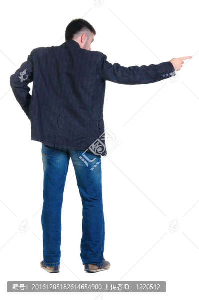 指著墻的年輕人。后視圖。