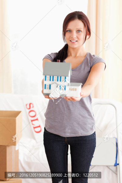 一位年輕女子舉著樣板房的肖像
