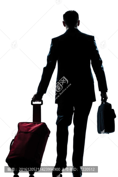 商務(wù)旅行者步行與手提箱后視圖
