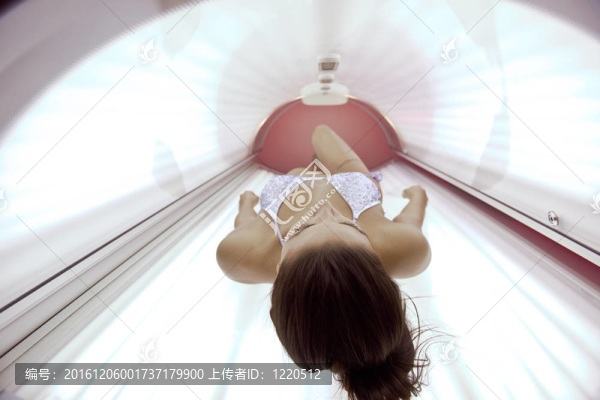 美麗的年輕女子曬日光浴