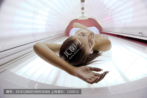 美麗的年輕女子曬日光浴